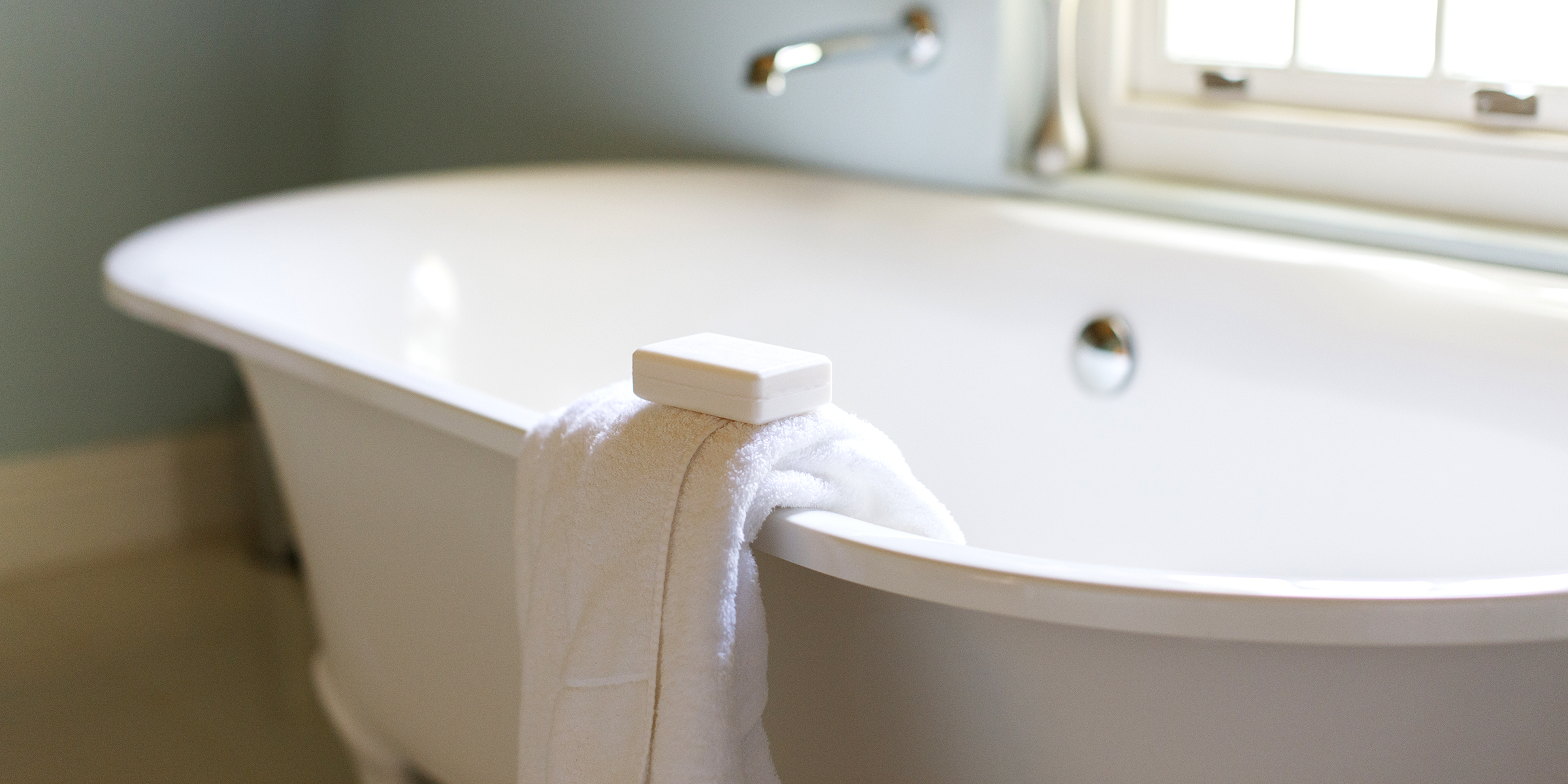 Bar Soap And Towel On Ledge Of Claw Foot Tub
